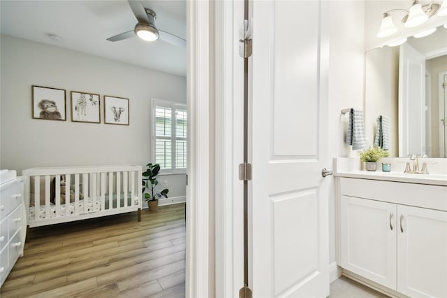 8766 Shadyside Ln, Land O Lakes, FL 34637 - bathroom with vanity, a ceiling fan, and wood finished floors