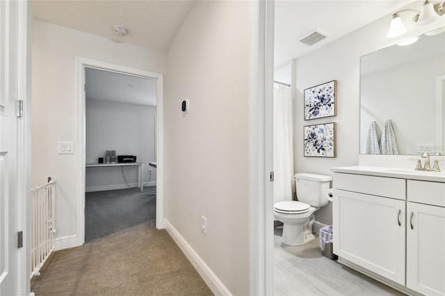 8766 Shadyside Ln, Land O Lakes, FL 34637 - bathroom with toilet, vanity, and baseboards