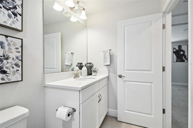 8766 Shadyside Ln, Land O Lakes, FL 34637 - bathroom with toilet, vanity, and baseboards