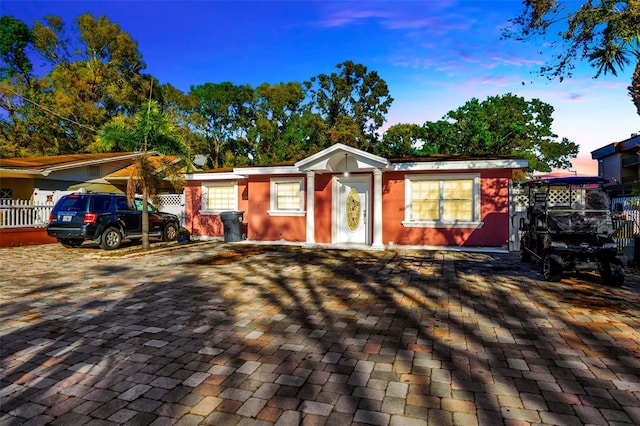 ranch-style house with fence