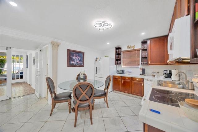 kitchen featuring white appliances, tile countertops, open shelves, a sink, and crown molding