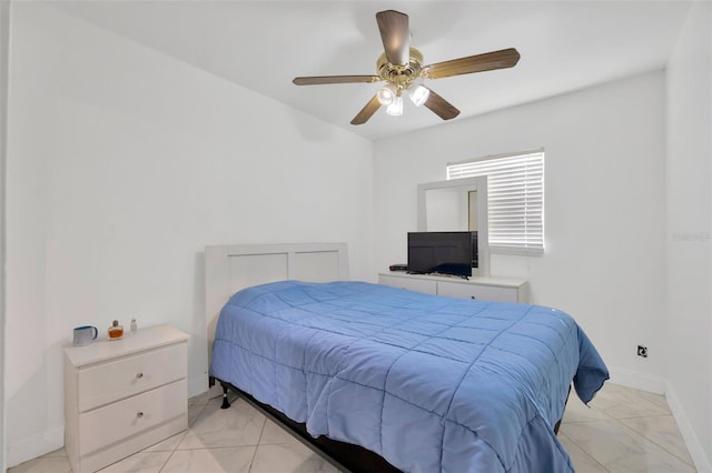 bedroom with a ceiling fan and baseboards