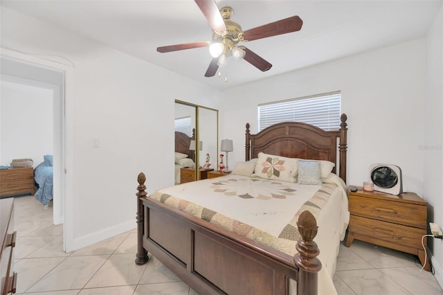 bedroom featuring a closet, baseboards, and ceiling fan