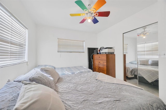 bedroom with a ceiling fan and a closet