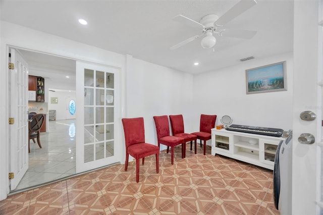 sitting room with light tile patterned floors, visible vents, recessed lighting, and a ceiling fan