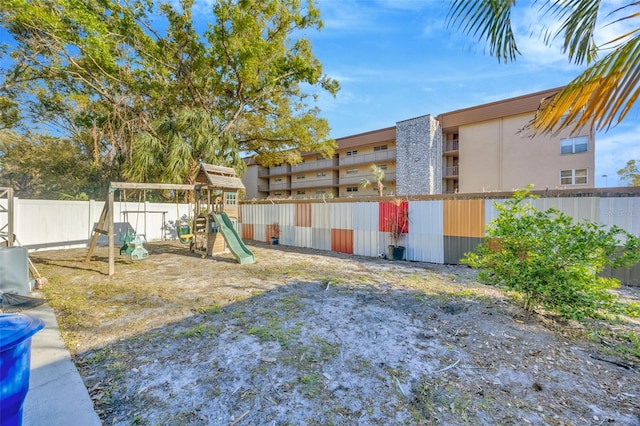 view of yard featuring a playground and fence