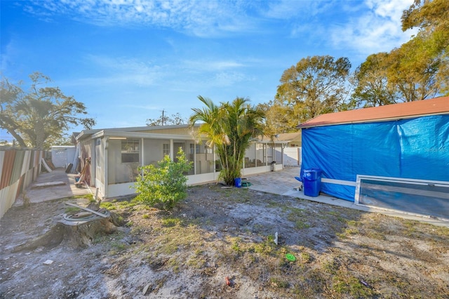 view of yard with a fenced backyard and a sunroom