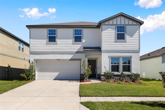 view of front of home with board and batten siding, concrete driveway, a front yard, stucco siding, and an attached garage