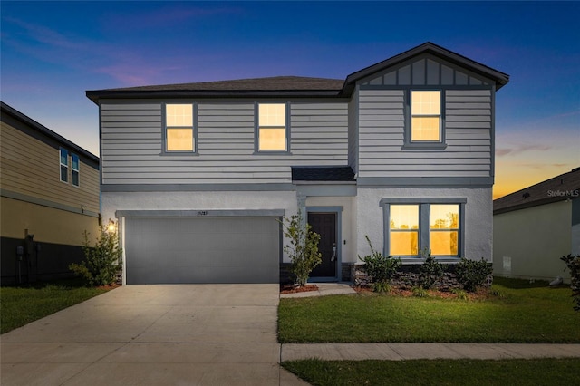 view of front of home with a garage, board and batten siding, concrete driveway, and stucco siding