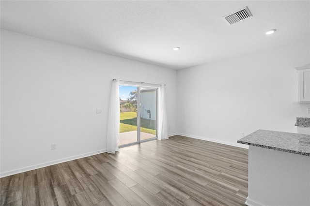 interior space with recessed lighting, visible vents, light wood-style flooring, and baseboards