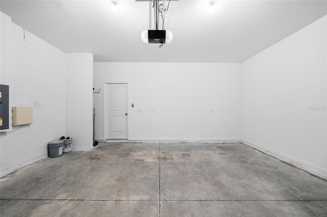 garage featuring electric panel, a garage door opener, and concrete block wall