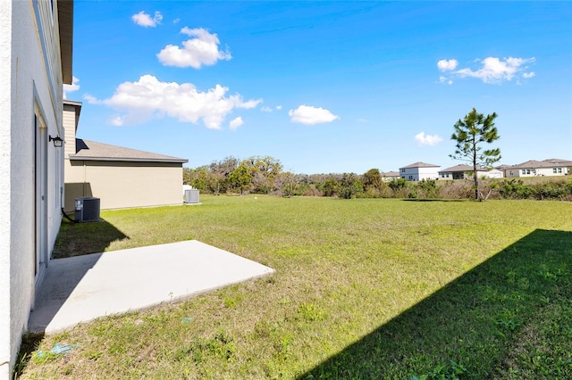 view of yard with a patio and central AC unit