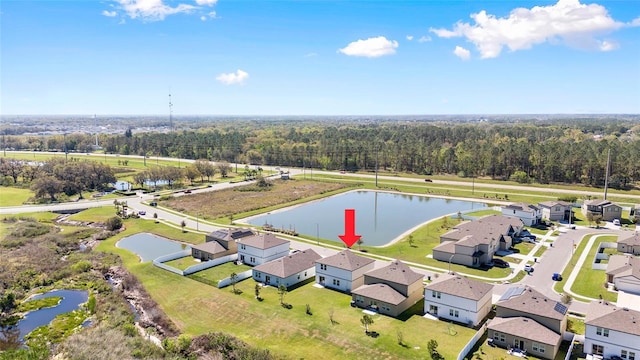 aerial view featuring a forest view, a water view, and a residential view