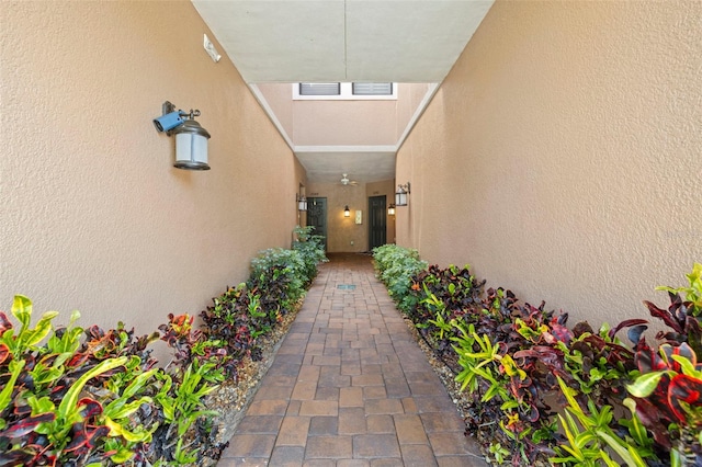 doorway to property featuring visible vents and stucco siding