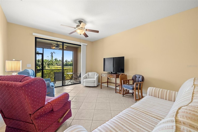 tiled living room featuring baseboards and a ceiling fan