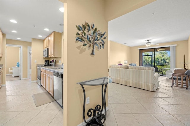 kitchen with open floor plan, recessed lighting, appliances with stainless steel finishes, light tile patterned floors, and ceiling fan