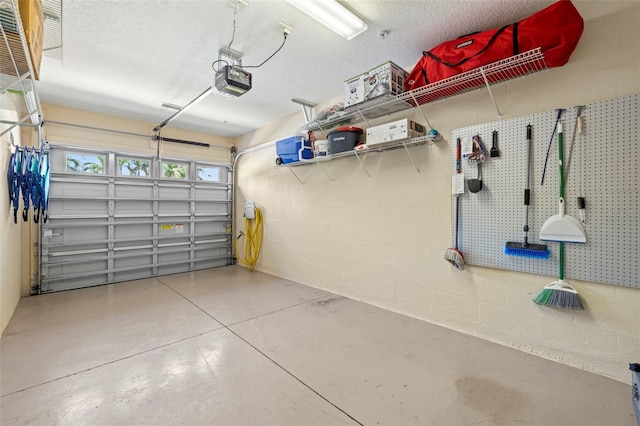 garage with concrete block wall and a garage door opener