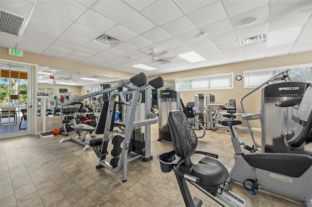 gym featuring a ceiling fan, visible vents, and a drop ceiling