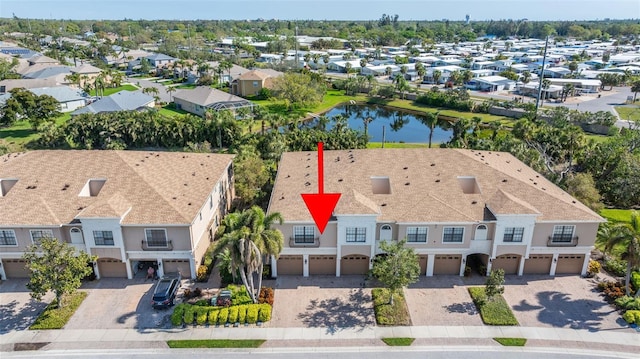 drone / aerial view featuring a residential view and a water view