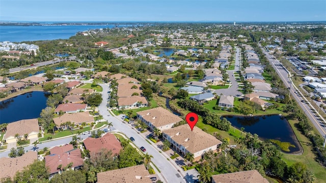 birds eye view of property featuring a residential view and a water view