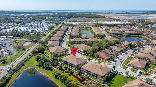 bird's eye view with a residential view and a water view