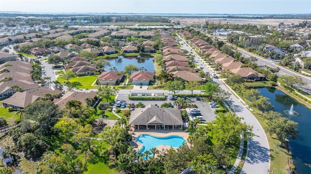 drone / aerial view with a residential view and a water view