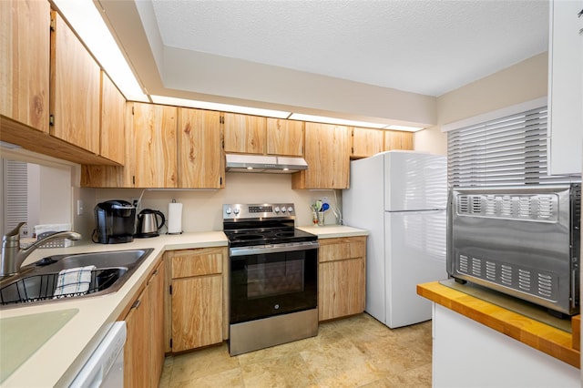 kitchen featuring under cabinet range hood, white appliances, a textured ceiling, and a sink