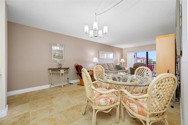 dining area with a notable chandelier, baseboards, and a textured ceiling