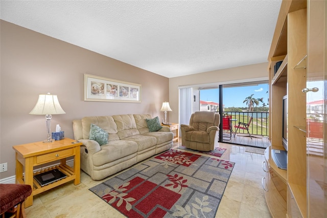 living area featuring a textured ceiling