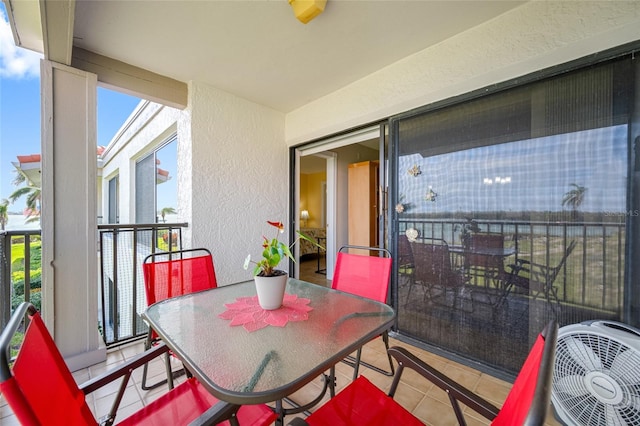 balcony with outdoor dining space and a sunroom