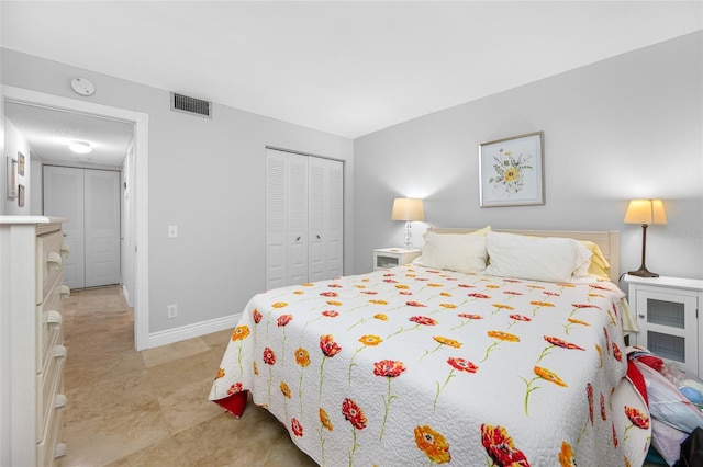 bedroom with a closet, visible vents, and baseboards