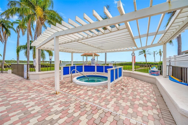 view of patio / terrace with a community hot tub and a pergola