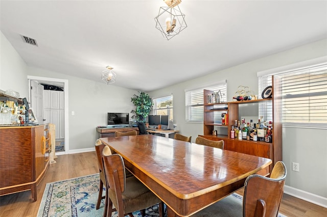 dining room with visible vents, baseboards, and wood finished floors