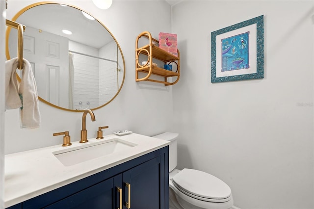 bathroom with vanity, curtained shower, and toilet