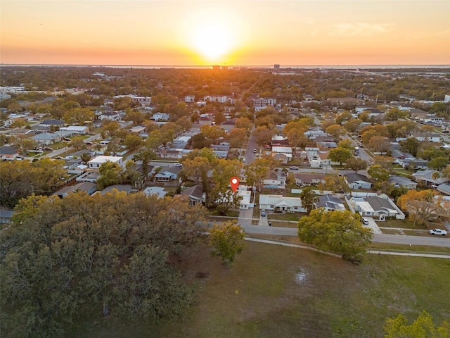 aerial view at dusk featuring a residential view