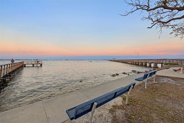 dock area featuring a beach view and a water view