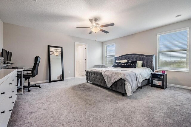 bedroom featuring baseboards, multiple windows, and light colored carpet