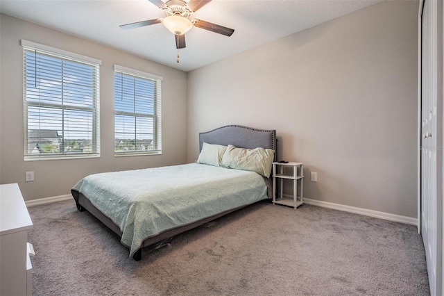 carpeted bedroom with baseboards and ceiling fan