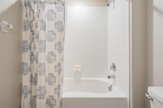 bathroom with shower / tub combo and toilet