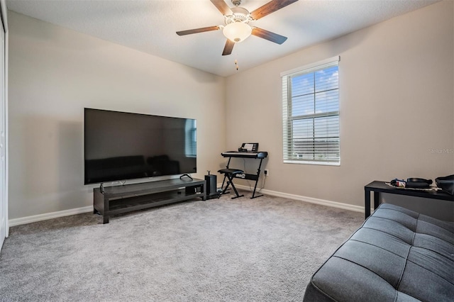 living room with baseboards, carpet floors, and ceiling fan