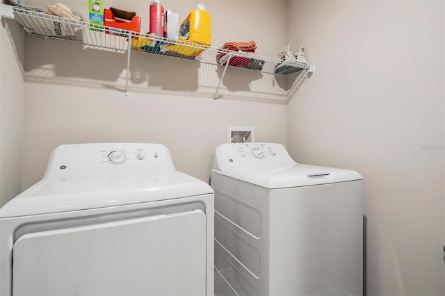 laundry room with laundry area and washing machine and clothes dryer