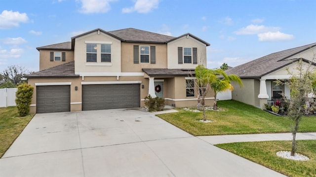 traditional home with stucco siding, concrete driveway, a front yard, and fence