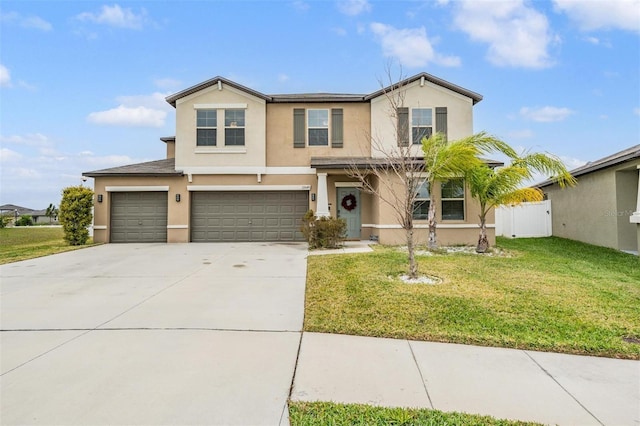 traditional-style home featuring an attached garage, fence, a front yard, stucco siding, and driveway