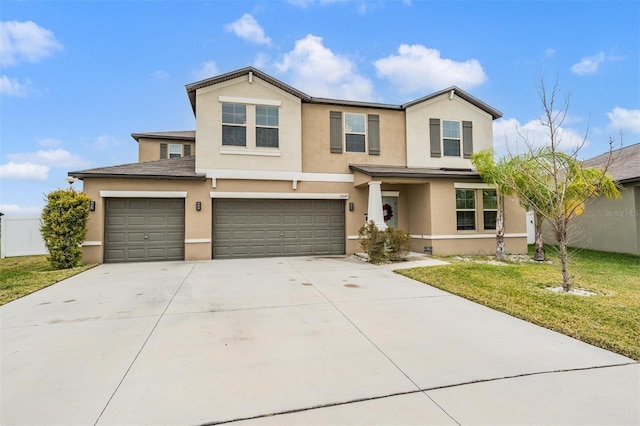 traditional home with a front yard, an attached garage, driveway, and stucco siding