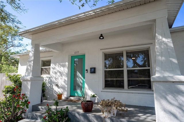 property entrance featuring stucco siding