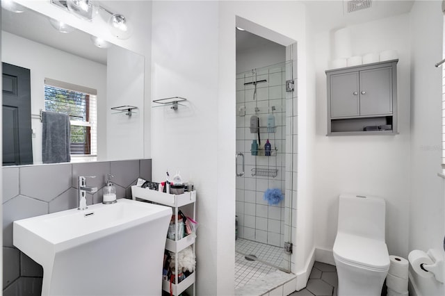 full bathroom featuring a sink, visible vents, toilet, and a stall shower