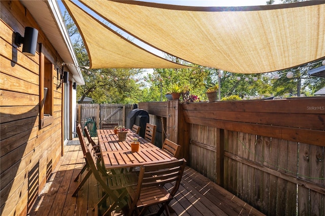 wooden deck featuring outdoor dining area and fence