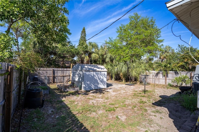 view of yard featuring a fenced backyard, a storage shed, and an outdoor structure