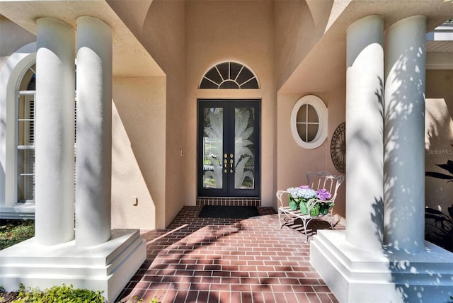 doorway to property with french doors and stucco siding