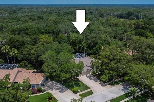 birds eye view of property featuring a view of trees